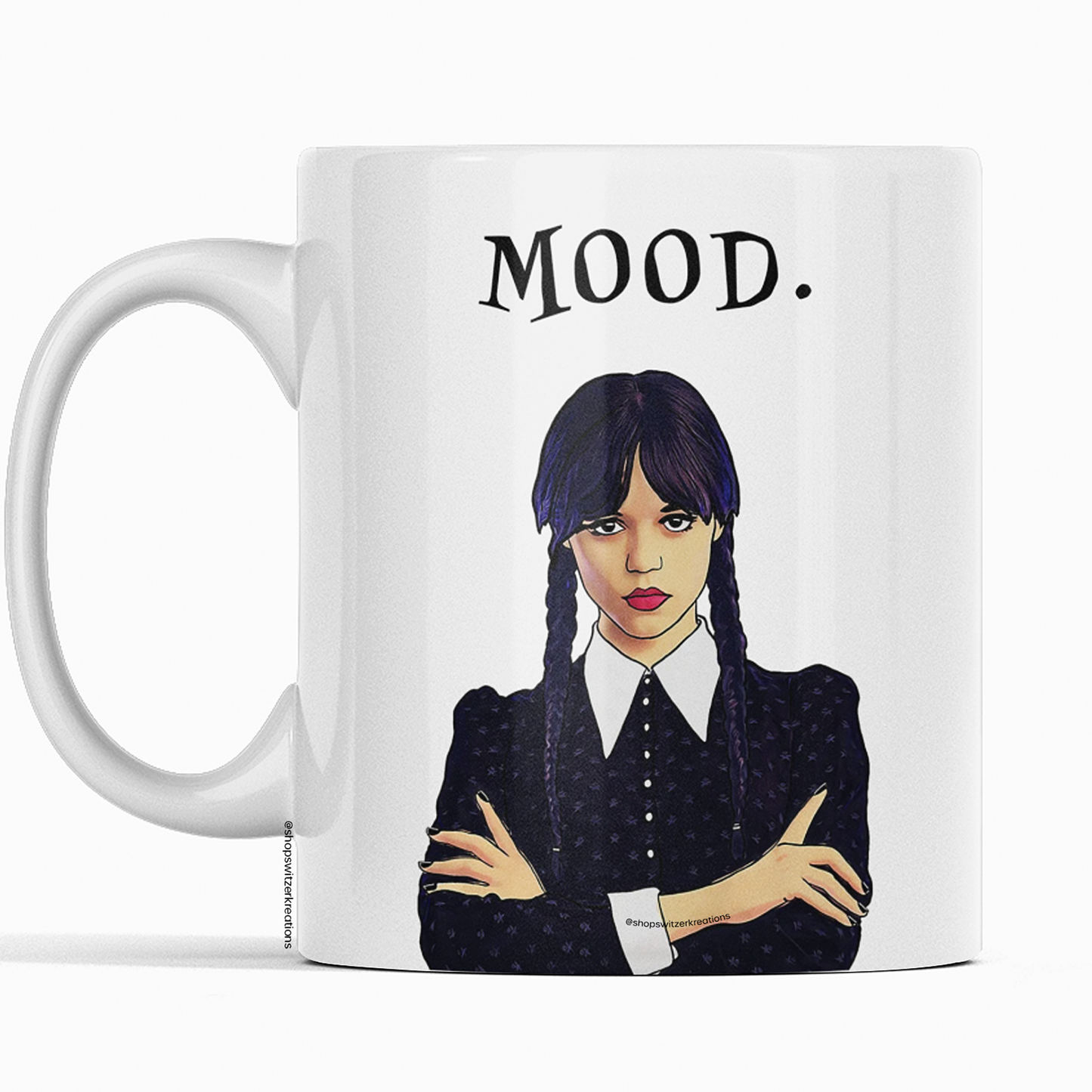 An 11 Oz white ceramic coffee mug featuring an illustration of Wednesday Addams with a deadpan expression. Below the image is the word “MOOD” in bold, black text. The design is printed on both sides, making it suitable for right- or left-handed users. A perfect gift for fans of dark humor and gothic style.