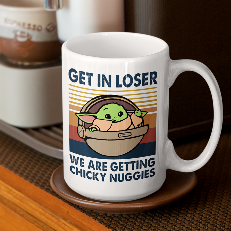 A white ceramic coffee mug featuring an illustration of Grogu in a hover pram with the funny phrase "Get In Loser, We Are Getting Chicky Nuggies." The design is printed on both sides, making it perfect for right- or left-handed users. A cute and humorous gift for sci-fi fans, coffee lovers, and pop culture enthusiasts.