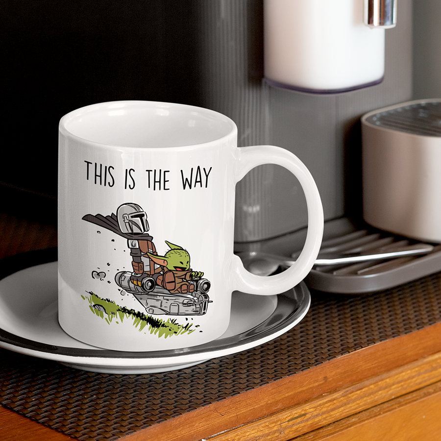15oz Ceramic coffee mug featuring the Mandalorian and Grogu flying together in a spaceship with the phrase 'This Is The Way' – perfect gift for Star Wars fans.