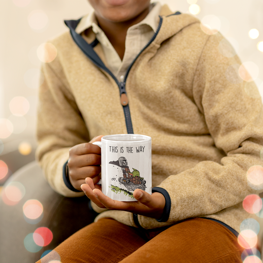 15oz Ceramic coffee mug featuring the Mandalorian and Grogu flying together in a spaceship with the phrase 'This Is The Way' – perfect gift for Star Wars fans.