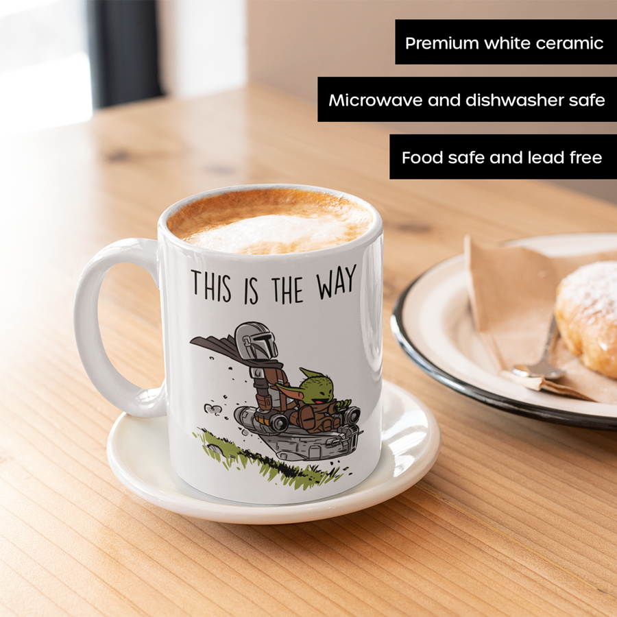 11oz Ceramic coffee mug featuring the Mandalorian and Grogu flying together in a spaceship with the phrase 'This Is The Way' – perfect gift for Star Wars fans.