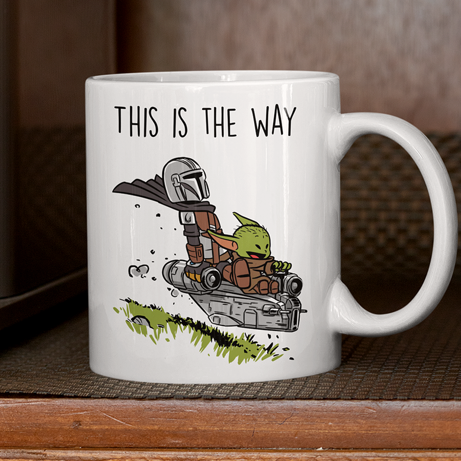15oz Ceramic coffee mug featuring the Mandalorian and Grogu flying together in a spaceship with the phrase 'This Is The Way' – perfect gift for Star Wars fans.