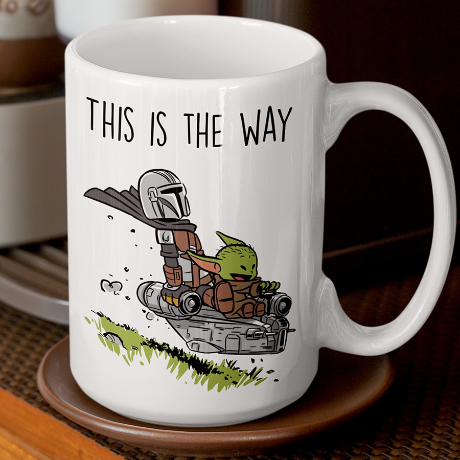 15oz Ceramic coffee mug featuring the Mandalorian and Grogu flying together in a spaceship with the phrase 'This Is The Way' – perfect gift for Star Wars fans.