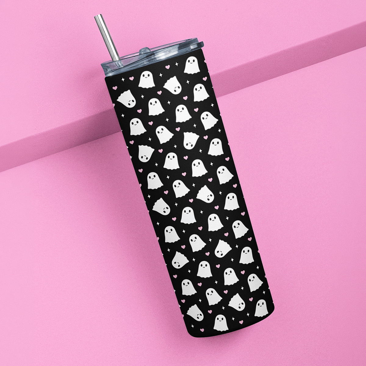 Cute black 20 oz ghost tumbler with pink hearts and stainless steel straw on a pink background