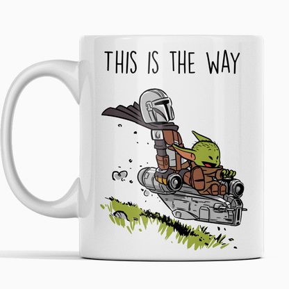 Ceramic coffee mug featuring the Mandalorian and Grogu flying together in a spaceship with the phrase 'This Is The Way' – perfect gift for Star Wars fans.